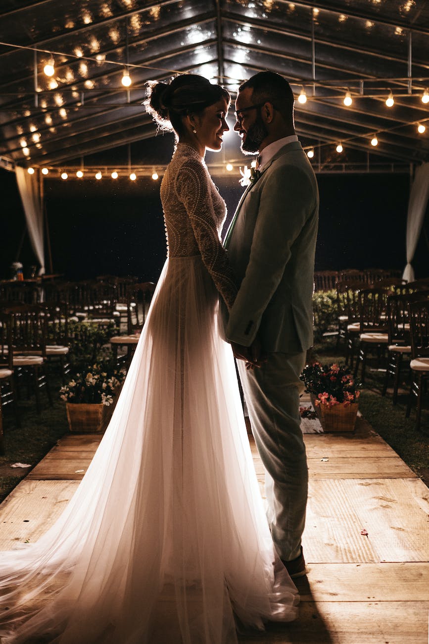 man standing in front of woman in white wedding dress